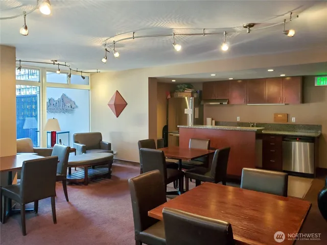 a living room with furniture a rug and a projector