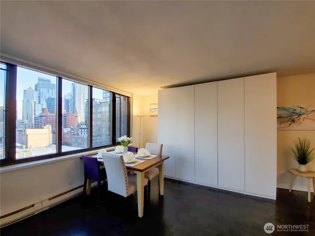 a room with furniture and large windows