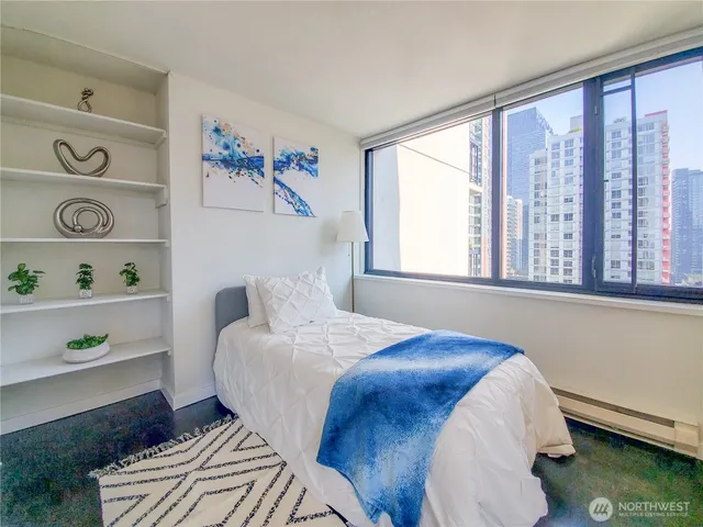 a bedroom with a bed and a window