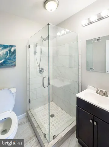 a bedroom with a bed and a night stand