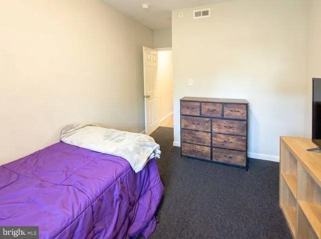 a white toilet sitting next to a shower
