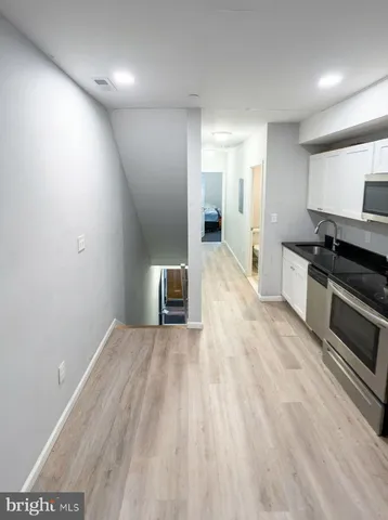 a bed sitting in a bedroom next to a window