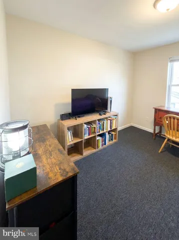 a bedroom with a bed a table and chair