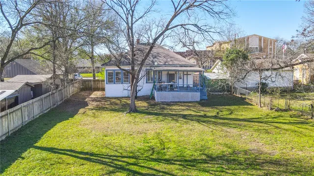 a swimming pool with outdoor seating and yard