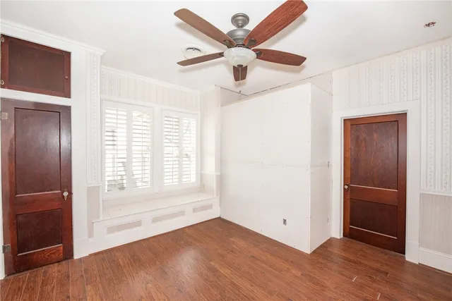 wooden floor in an empty room with a window