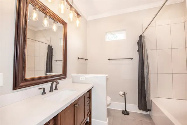 a bathroom with a sink a toilet and mirror