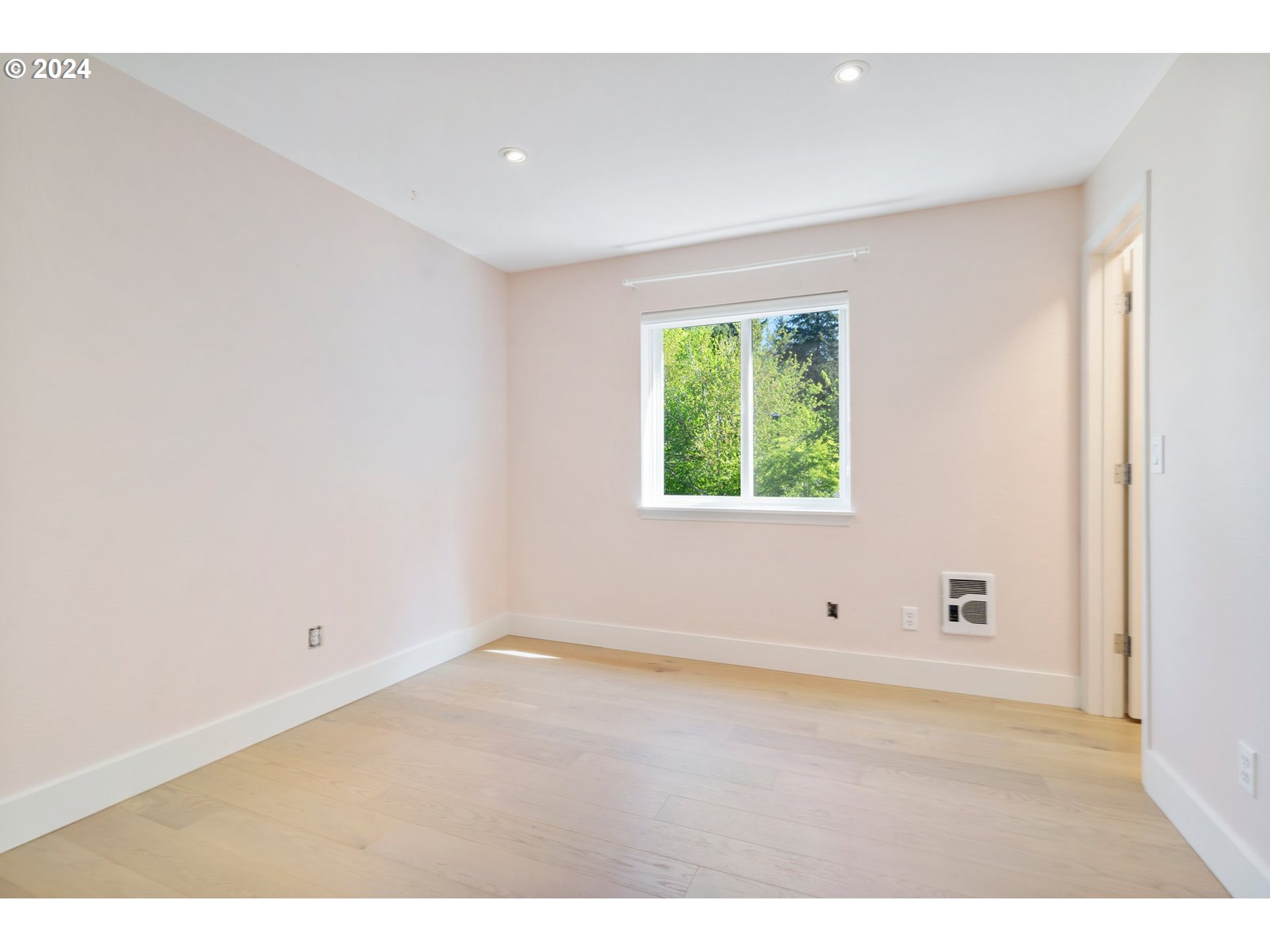 5225 Jean Road, Unit 501 Lake Oswego, OR 97035 - Photo 22 of 38 a view of an empty room with wooden floor and a window