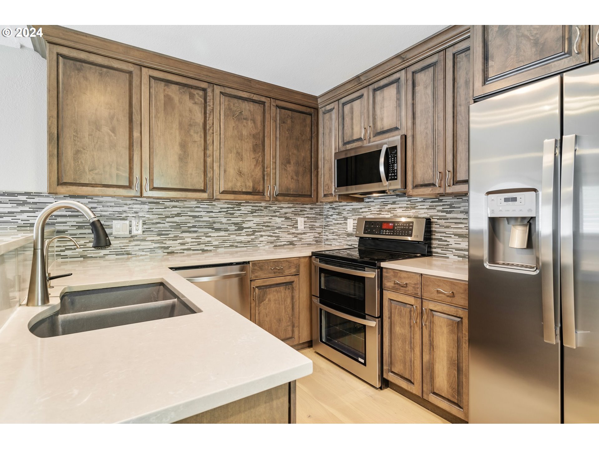 5225 Jean Road, Unit 501 Lake Oswego, OR 97035 - Photo 5 of 38 a kitchen with stainless steel appliances granite countertop a refrigerator stove sink and microwave