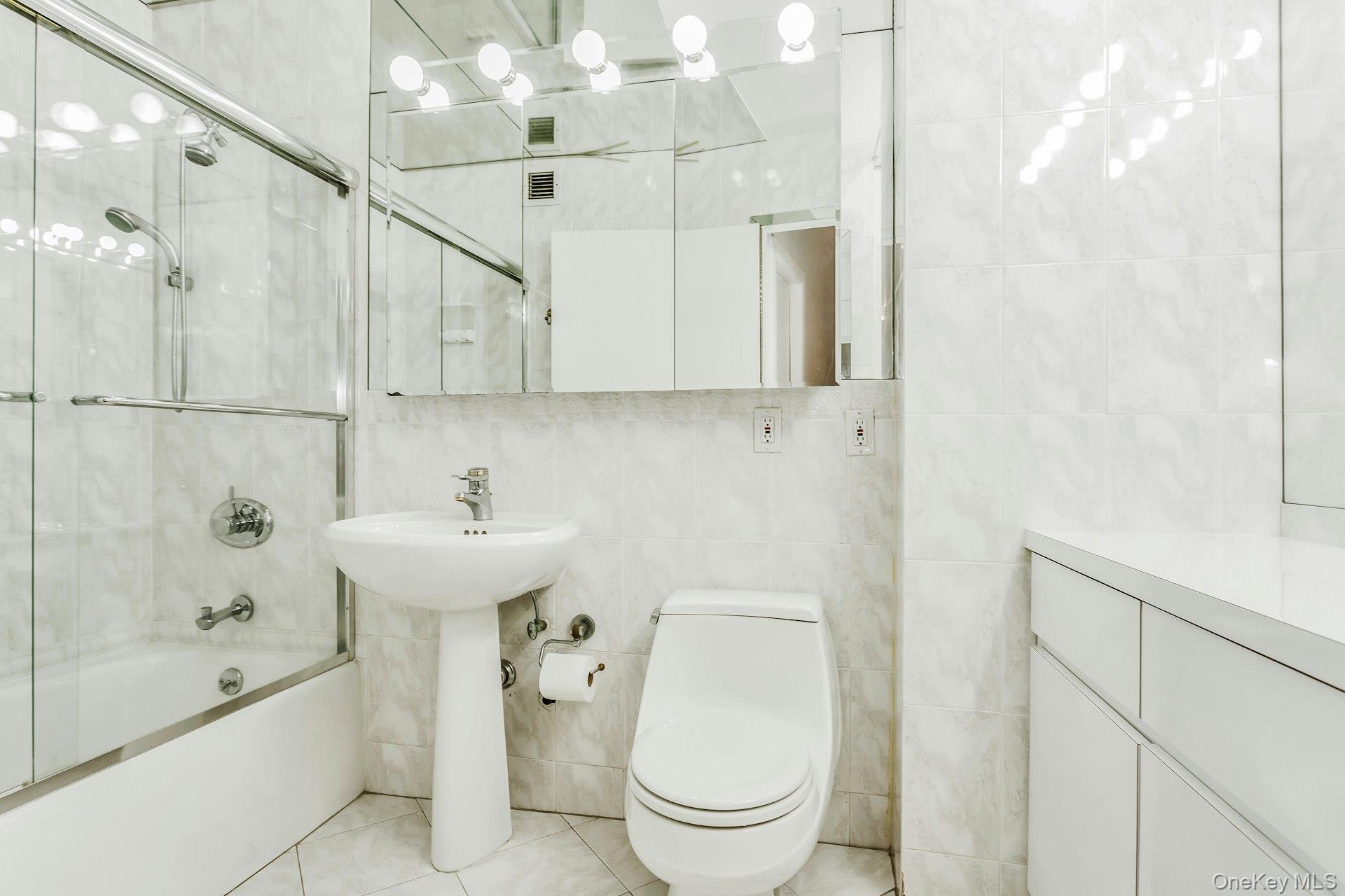 269 Grand Central Parkway, Unit 27T Queens, NY 11005 - Photo 14 of 43 a bathroom with a sink a toilet and shower