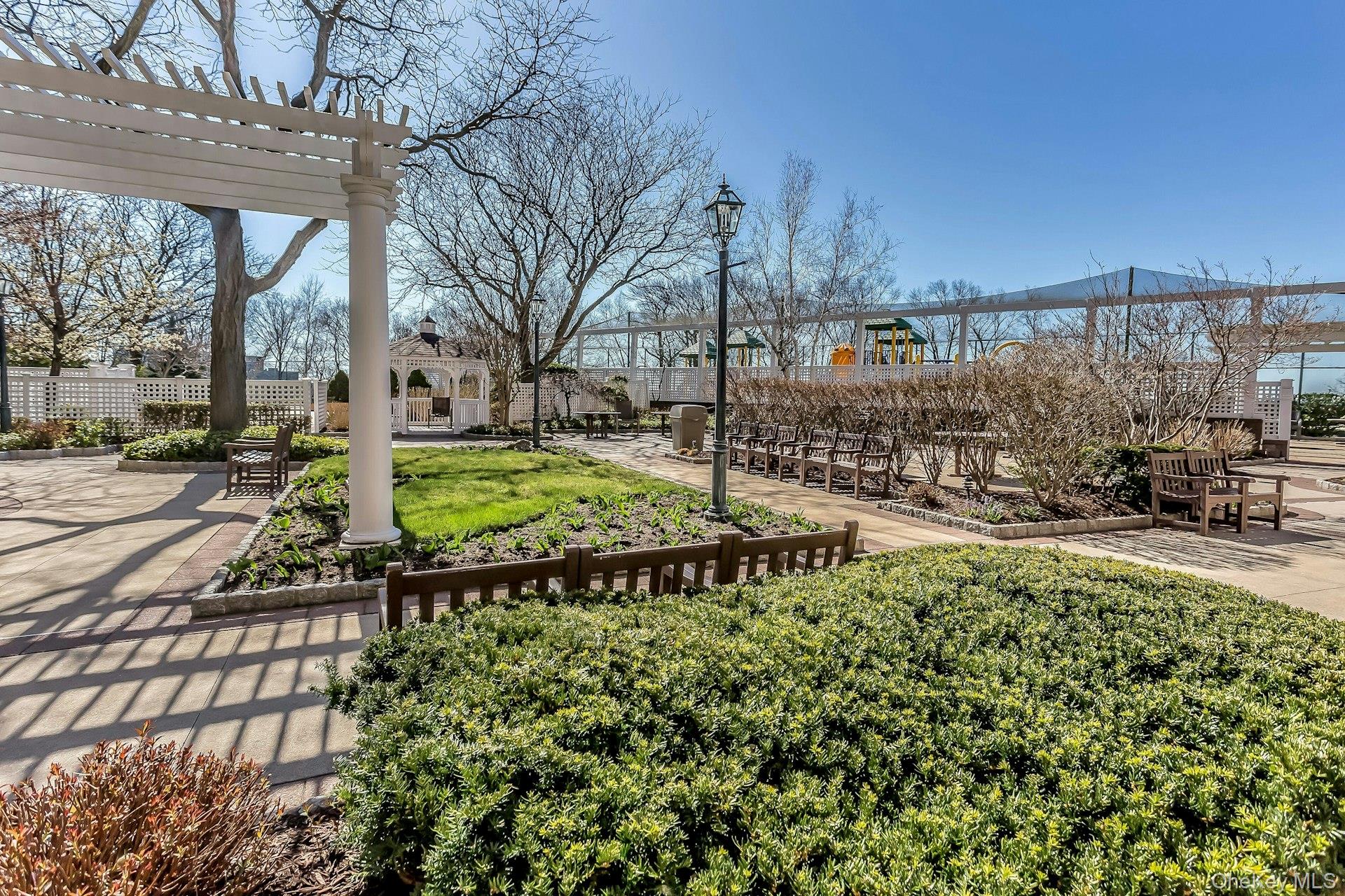 269 Grand Central Parkway, Unit 27T Queens, NY 11005 - Photo 29 of 43 a view of swimming pool with lawn chairs and wooden fence