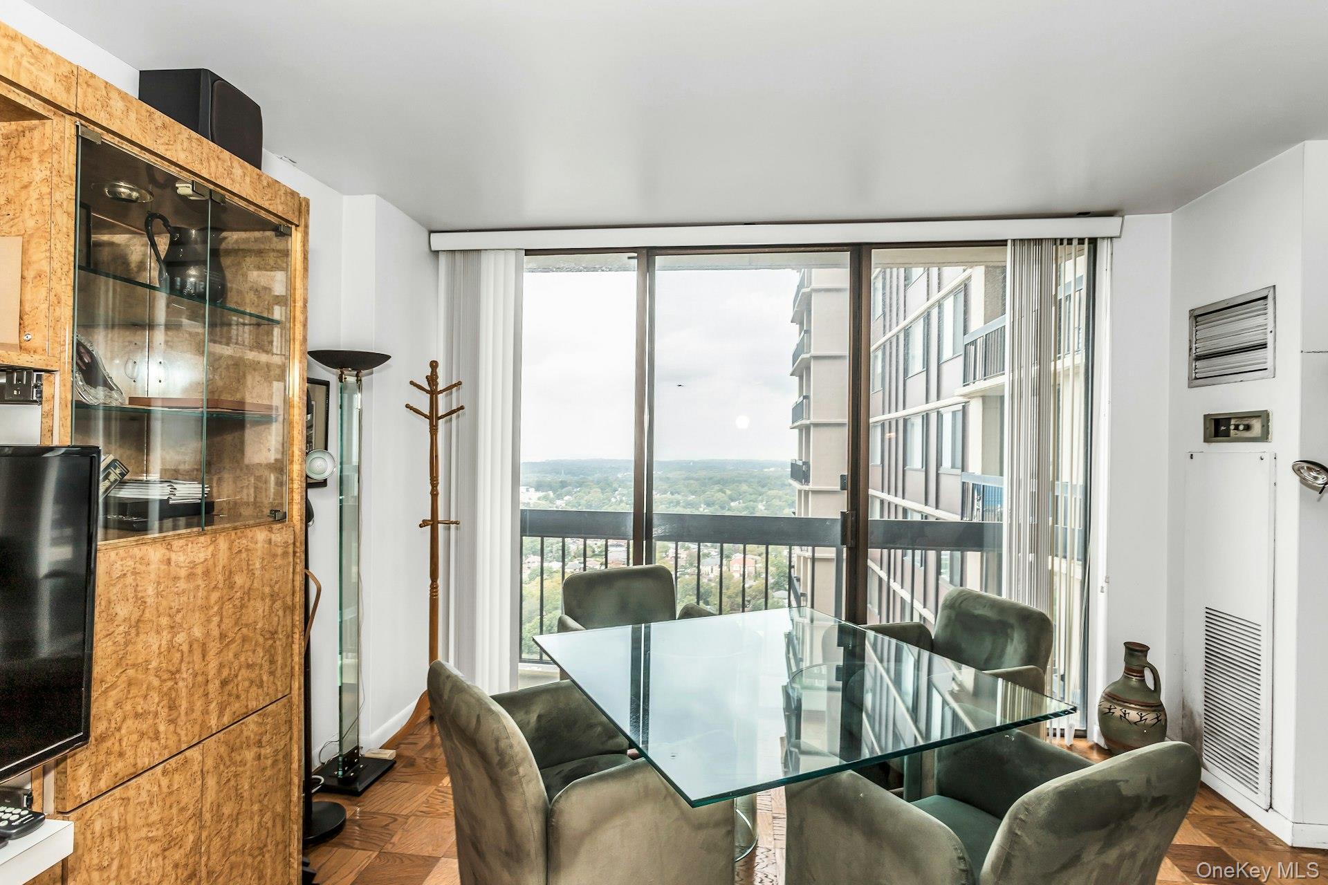 269 Grand Central Parkway, Unit 27T Queens, NY 11005 - Photo 7 of 43 a living room with furniture and a floor to ceiling window