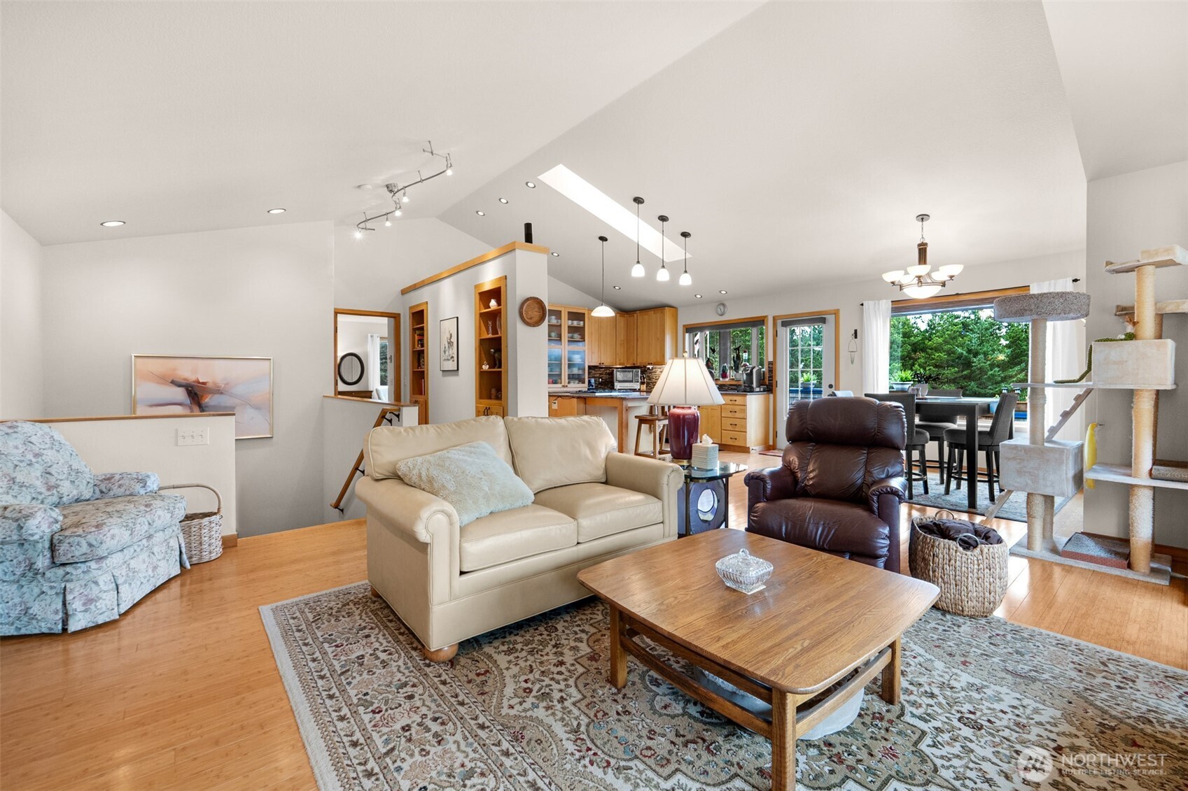 402 17th Street Southwest Long Beach, WA 98631 - Photo 11 of 32 a living room with furniture a rug and a chandelier