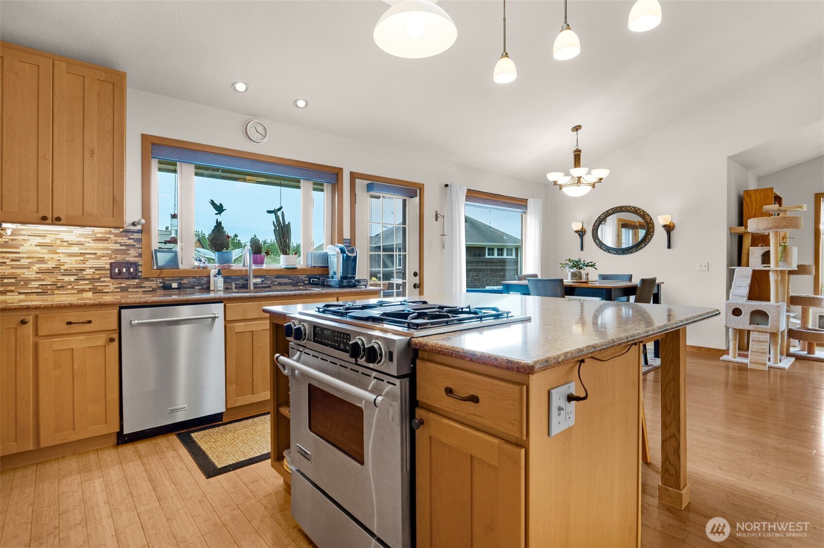 402 17th Street Southwest Long Beach, WA 98631 - Photo 6 of 32 a kitchen with granite countertop a stove top oven and cabinets