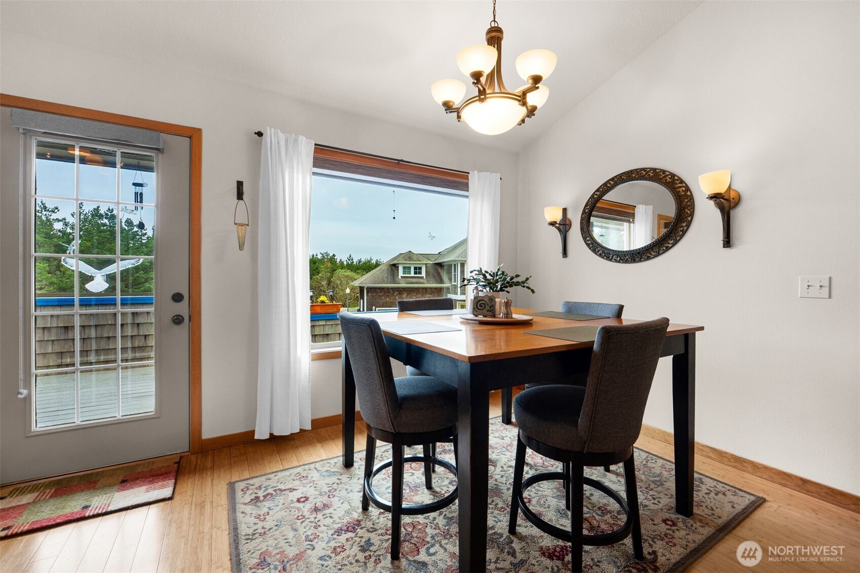 402 17th Street Southwest Long Beach, WA 98631 - Photo 7 of 32 a view of a dining room with furniture window and wooden floor