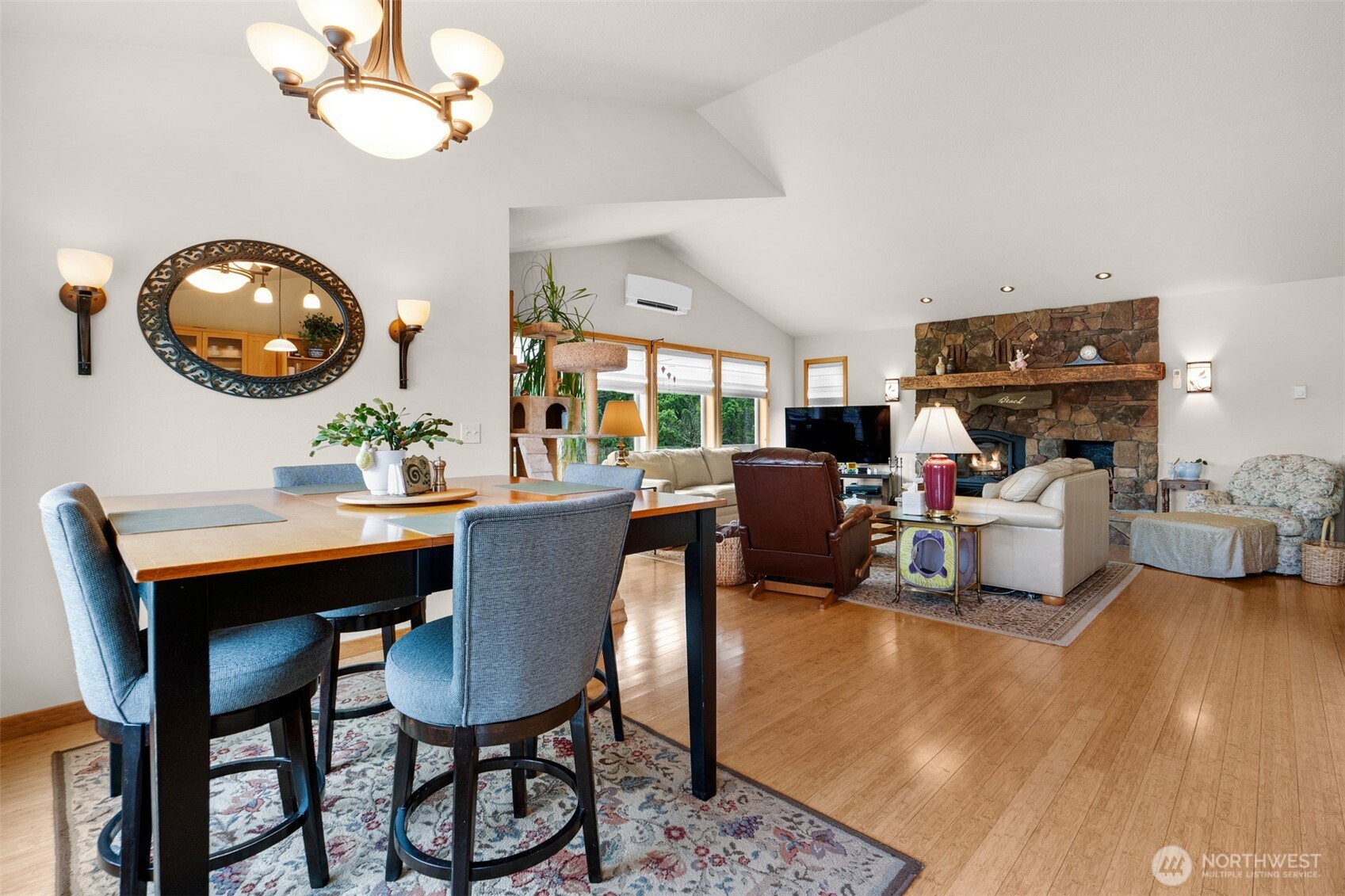 402 17th Street Southwest Long Beach, WA 98631 - Photo 9 of 32 a living room with furniture a chandelier and a large mirror