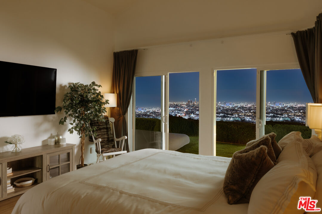 2669 Larmar Road Los Angeles, CA 90068 - Photo 14 of 16 a bedroom with a bed and a flat screen tv