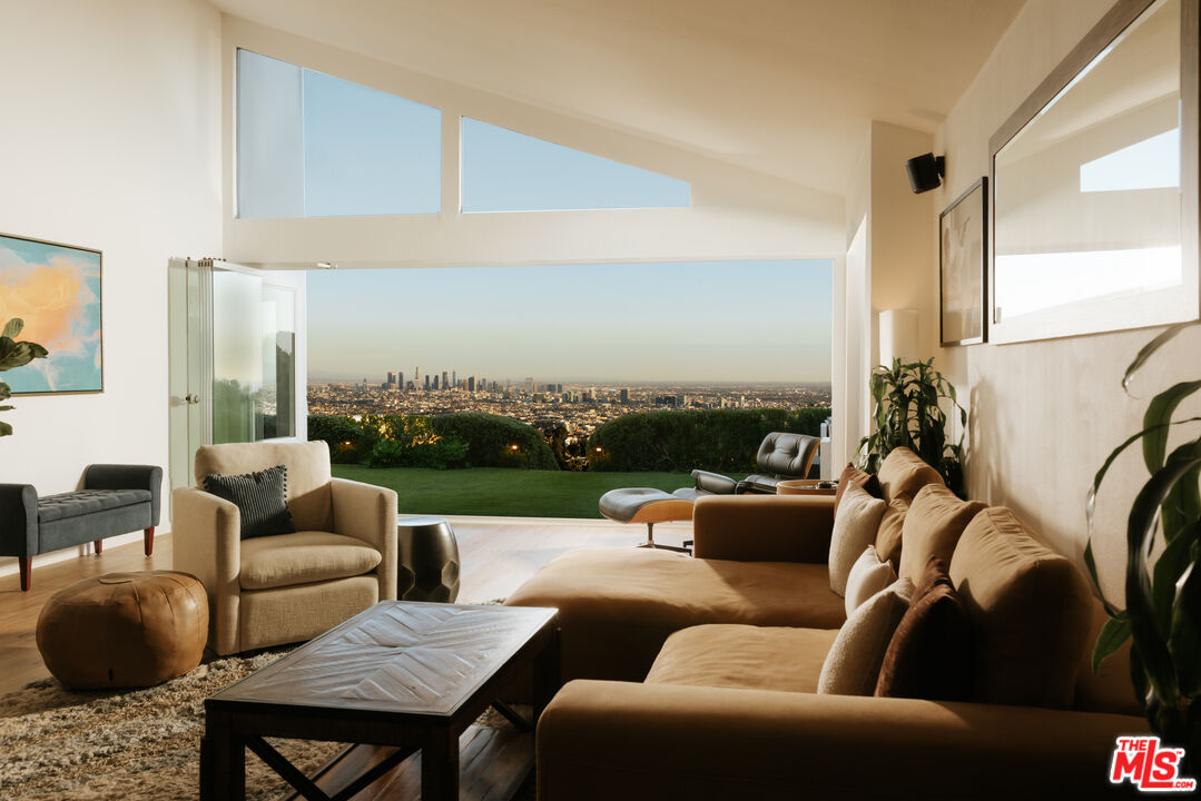 2669 Larmar Road Los Angeles, CA 90068 - Photo 5 of 16 a living room with furniture and a floor to ceiling window