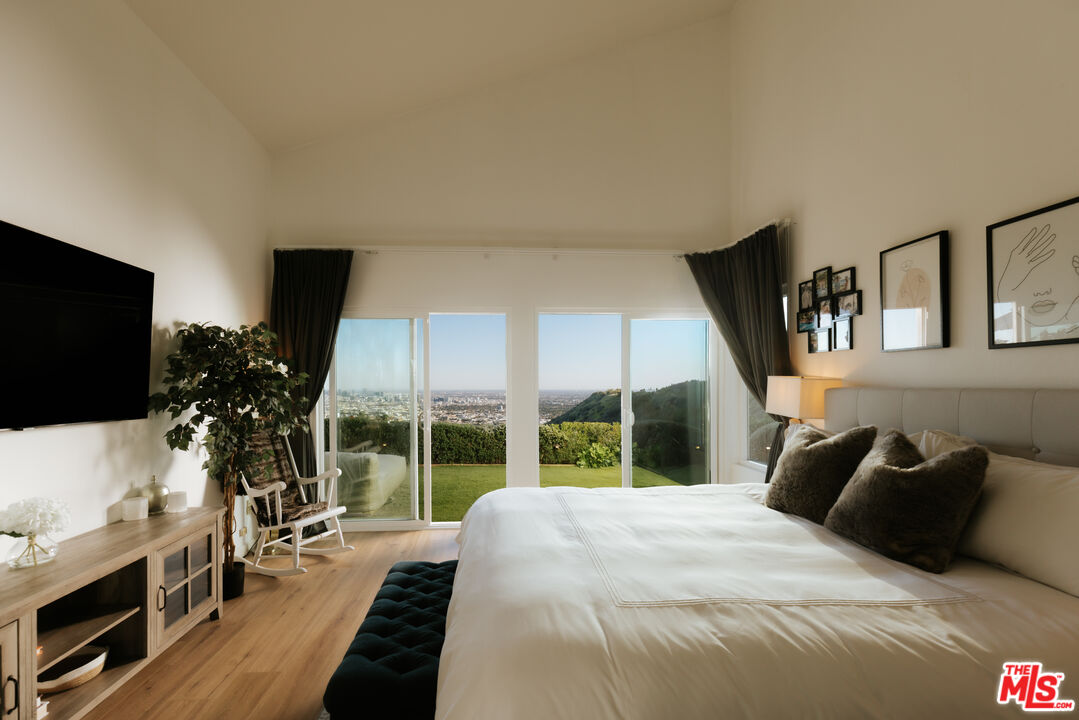 2669 Larmar Road Los Angeles, CA 90068 - Photo 7 of 16 a bed room with a bed and a television