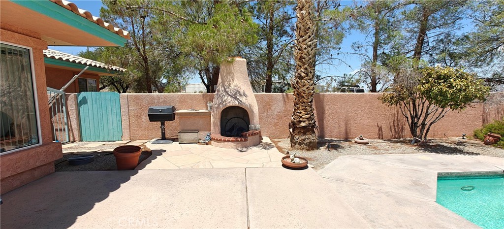 6144 Carodean Road Twentynine Palms, CA 92277 - Photo 12 of 71 a view of the patio with a table and chairs