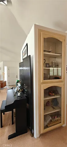 a living room with furniture a flat screen tv and kitchen view