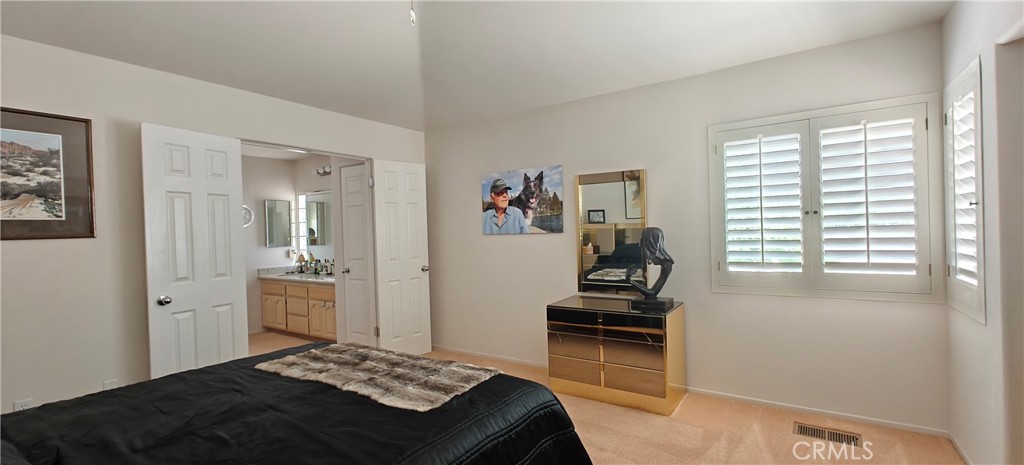 6144 Carodean Road Twentynine Palms, CA 92277 - Photo 27 of 71 a bedroom with a bed and a window