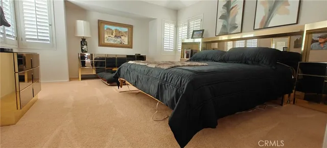 a kitchen with stainless steel appliances a white table chairs and a large window