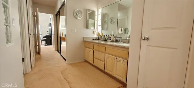 a kitchen with stainless steel appliances kitchen island granite countertop a refrigerator a sink a stove and white cabinets