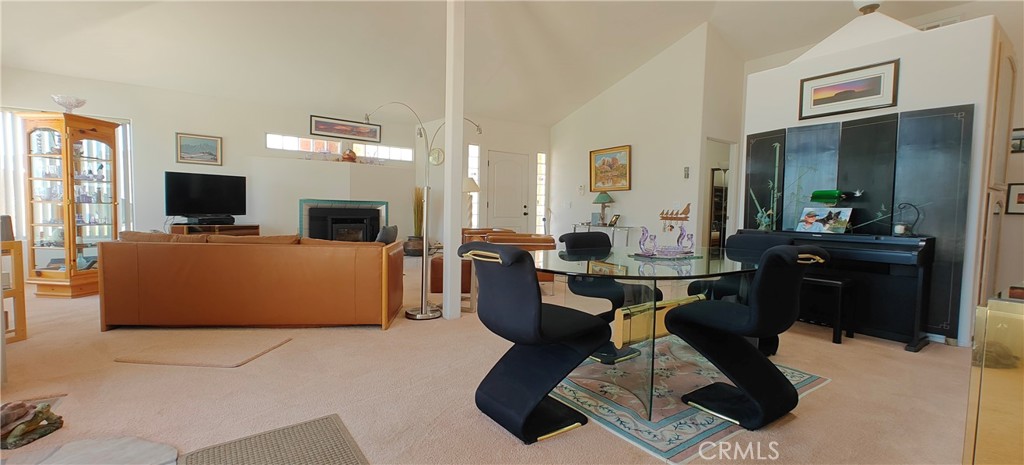 6144 Carodean Road Twentynine Palms, CA 92277 - Photo 35 of 71 a living room with furniture a flat screen tv and kitchen view