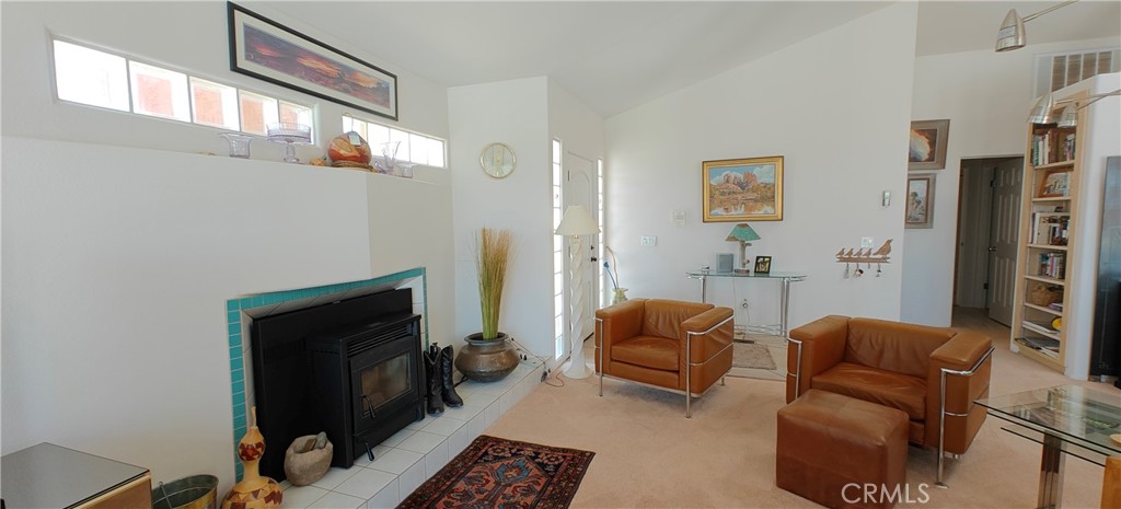 6144 Carodean Road Twentynine Palms, CA 92277 - Photo 38 of 71 a living room with furniture a flat screen tv and a fireplace