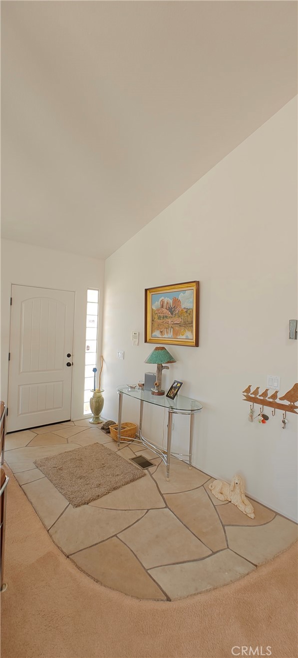 6144 Carodean Road Twentynine Palms, CA 92277 - Photo 40 of 71 a view of a bedroom with a bed and lamp on desk