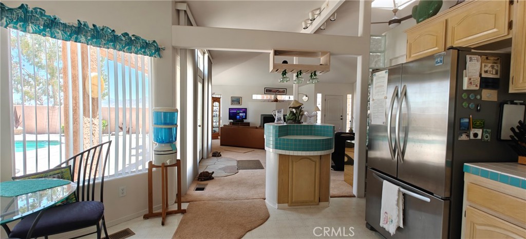 6144 Carodean Road Twentynine Palms, CA 92277 - Photo 50 of 71 a kitchen with stainless steel appliances kitchen island granite countertop a refrigerator and a sink