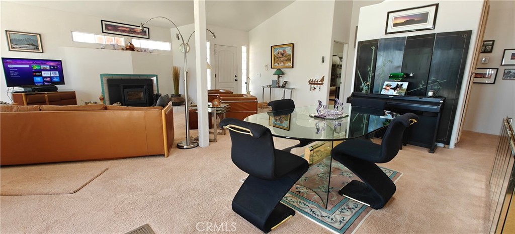 6144 Carodean Road Twentynine Palms, CA 92277 - Photo 52 of 71 a living room with furniture a fireplace and a flat screen tv