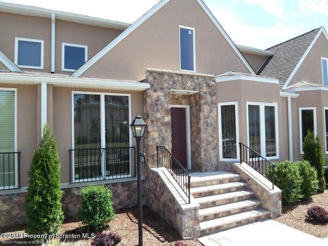 705 Green Ridge Street Scranton, PA 18509 - Photo 1 of 14 a view of house with large windows and plants