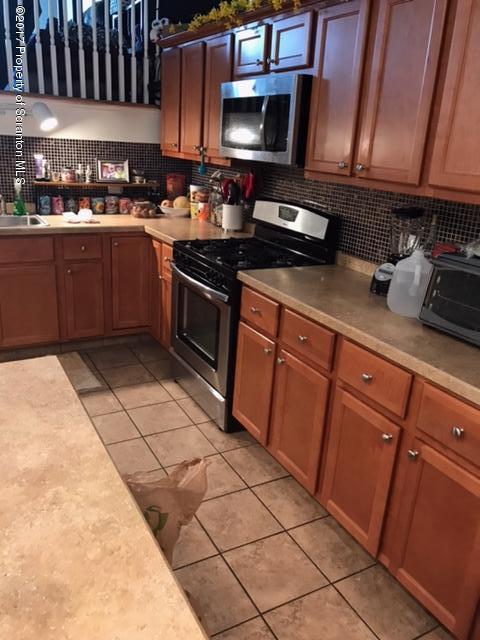 705 Green Ridge Street Scranton, PA 18509 - Photo 4 of 14 a kitchen with stainless steel appliances granite countertop a stove a sink and a microwave