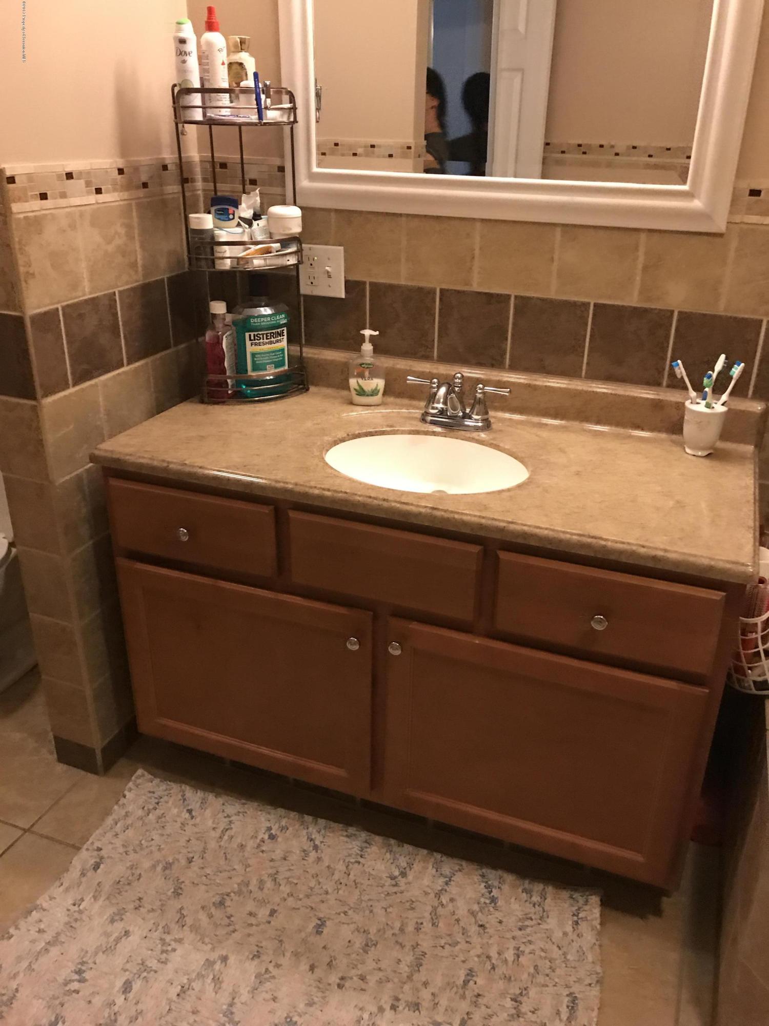 705 Green Ridge Street Scranton, PA 18509 - Photo 7 of 14 a bathroom with a sink and a mirror
