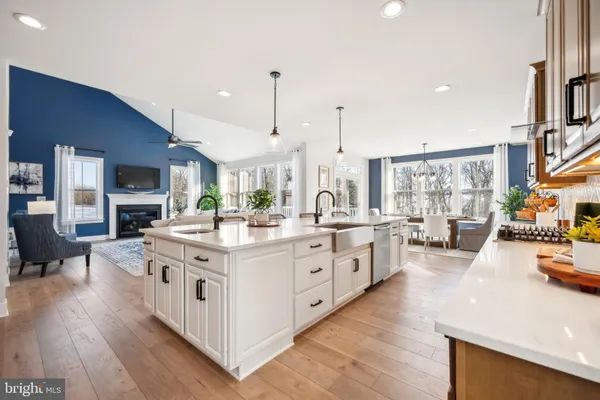 a large white kitchen with stainless steel appliances