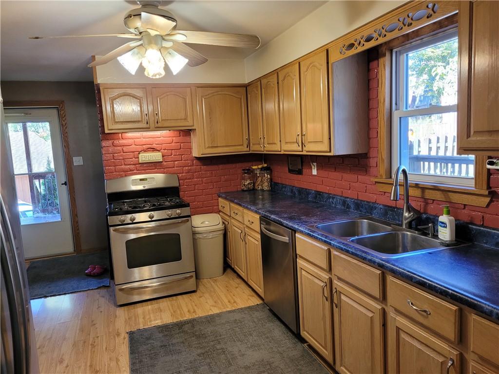 117 Thompson Road Sarver, PA 16055 - Photo 19 of 25 a kitchen with stainless steel appliances granite countertop a sink a stove cabinets and a wooden floor