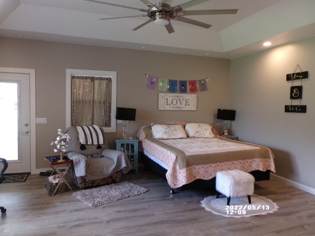 18-4177 North Peck Road Mountain View, HI 96771 - Photo 12 of 24 a bedroom with a bed and glass door
