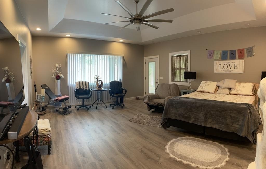 18-4177 North Peck Road Mountain View, HI 96771 - Photo 13 of 24 a spacious bedroom with a bed a table and chair