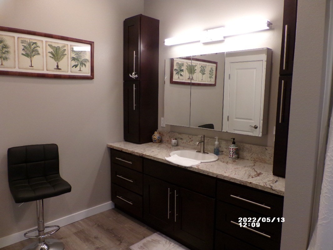 18-4177 North Peck Road Mountain View, HI 96771 - Photo 15 of 24 a bathroom with a sink a mirror and a vanity