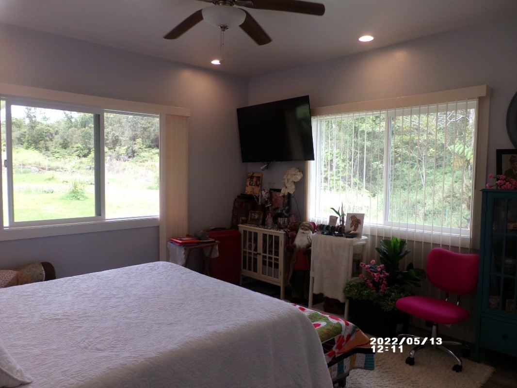 18-4177 North Peck Road Mountain View, HI 96771 - Photo 16 of 24 a bedroom with a bed and a flat screen tv