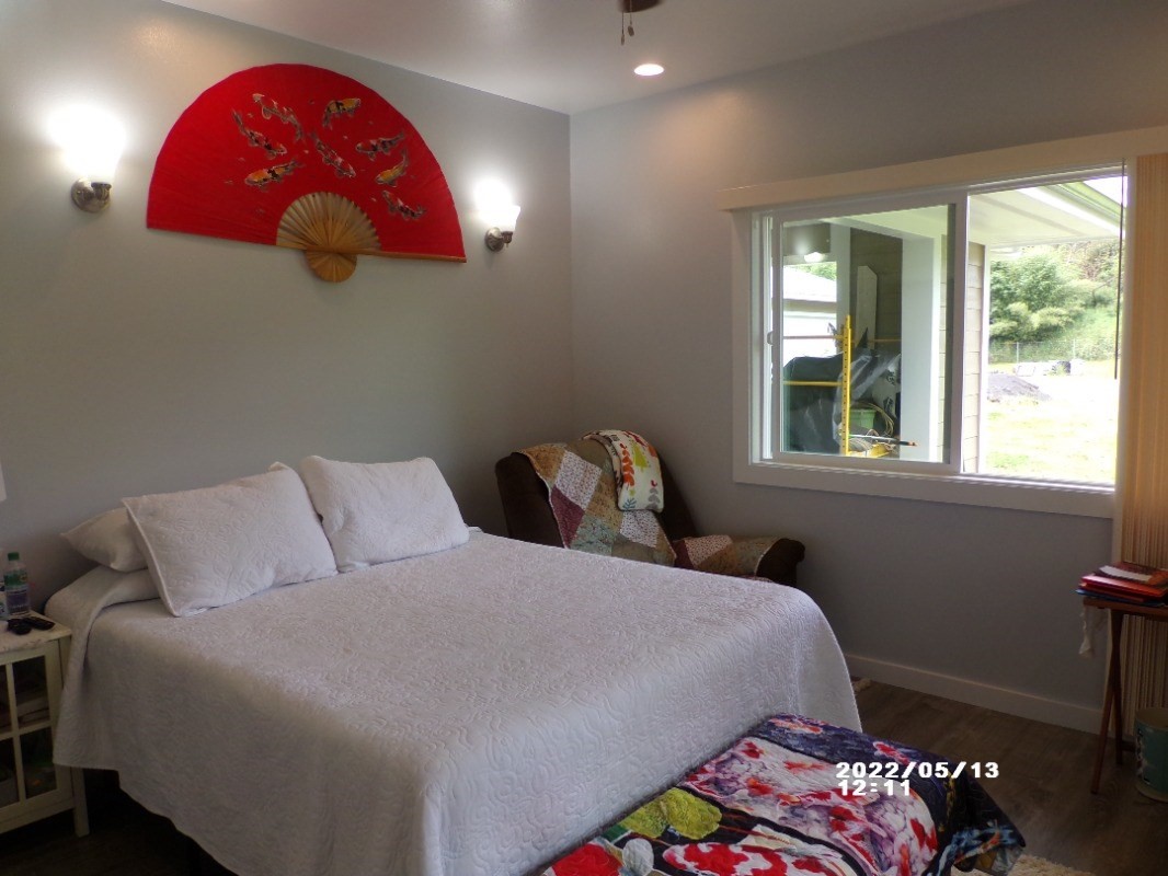 18-4177 North Peck Road Mountain View, HI 96771 - Photo 17 of 24 a bedroom with a bed and wooden floor