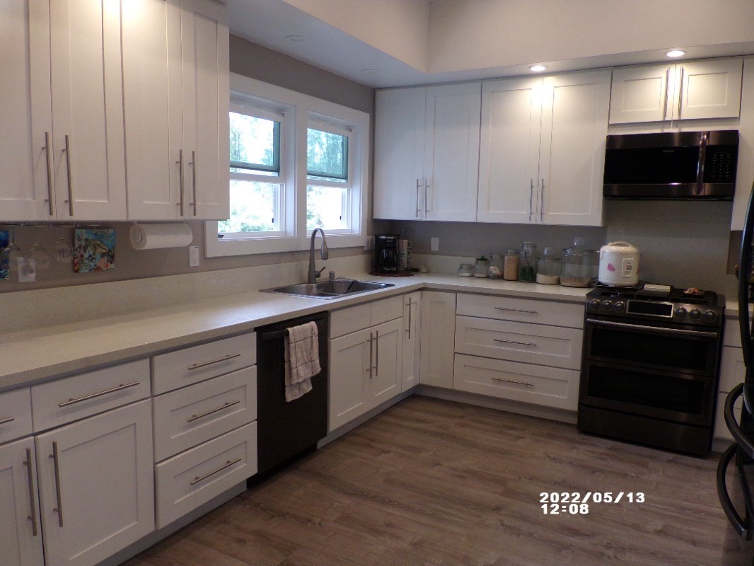 18-4177 North Peck Road Mountain View, HI 96771 - Photo 4 of 24 a kitchen with a sink stove and cabinets