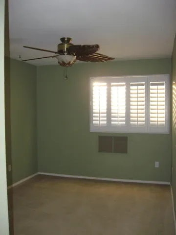 a view of a livingroom with an empty space and a window