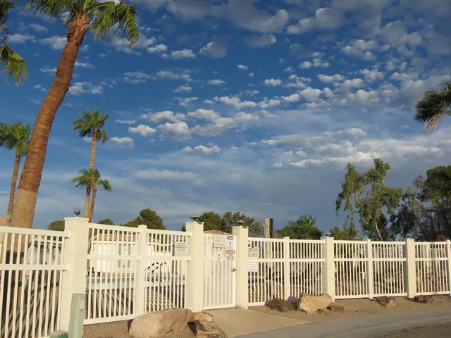 a front view of a house with a yard and lake view