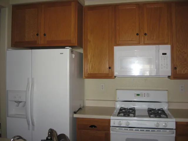 a stove top oven sitting inside of a kitchen