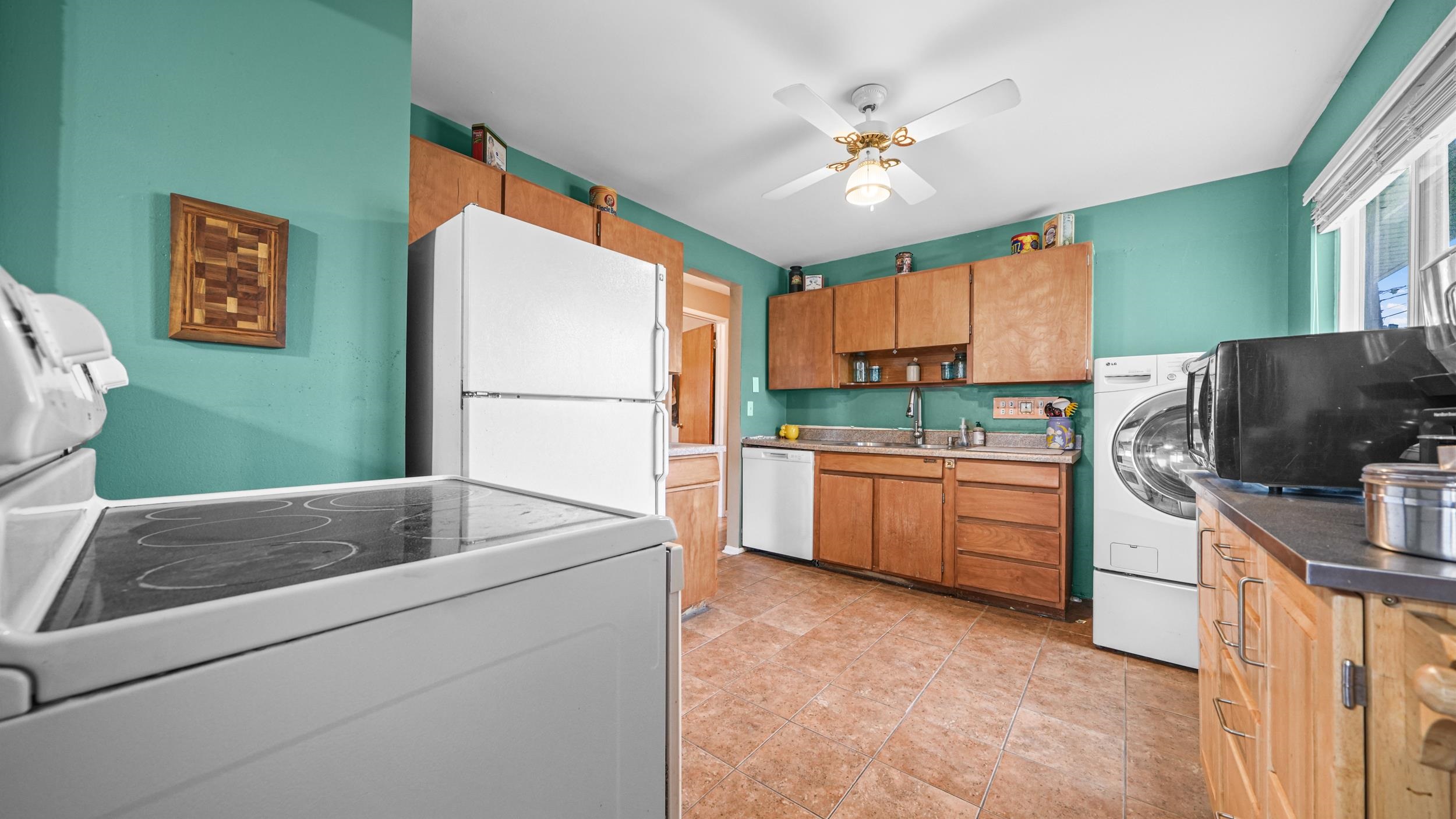 404 North 25th Street Grand Junction, CO 81501 - Photo 11 of 21 a kitchen with kitchen island a stove a sink and a refrigerator