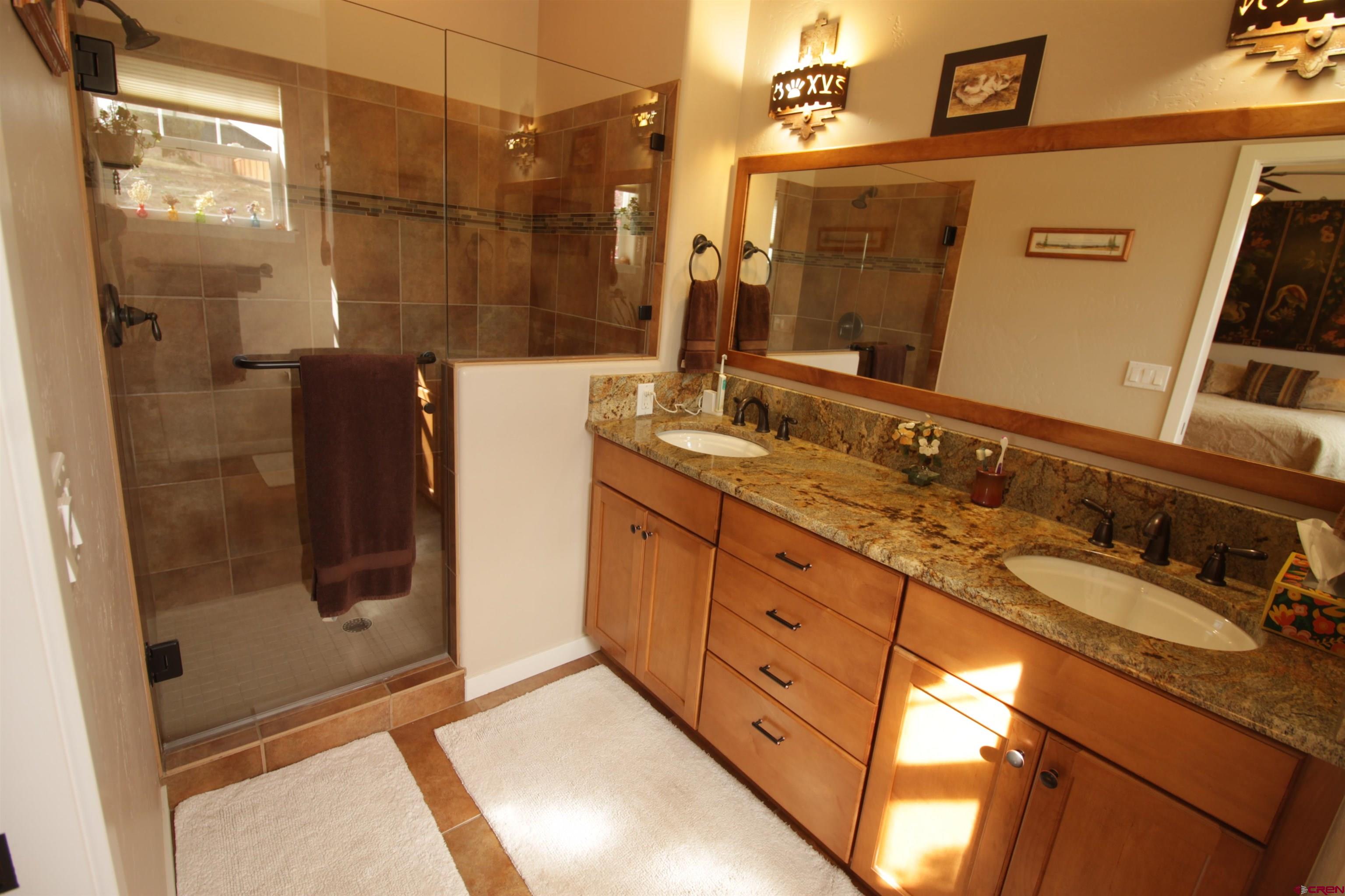 480 Oxbow Circle Durango, CO 81301 - Photo 11 of 16 a bathroom with a double vanity sink and a mirror