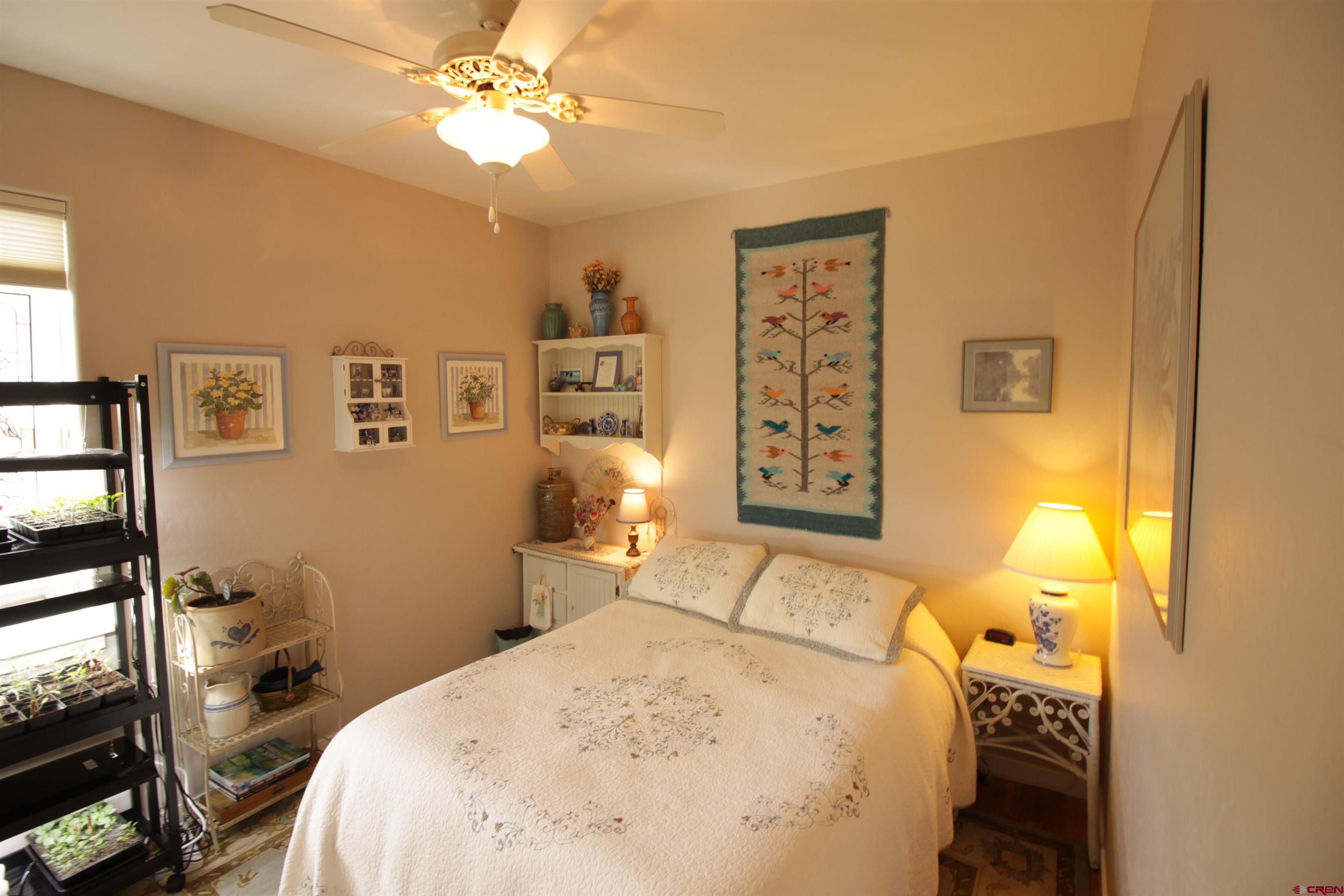 480 Oxbow Circle Durango, CO 81301 - Photo 13 of 16 a bedroom with a bed and a chandelier