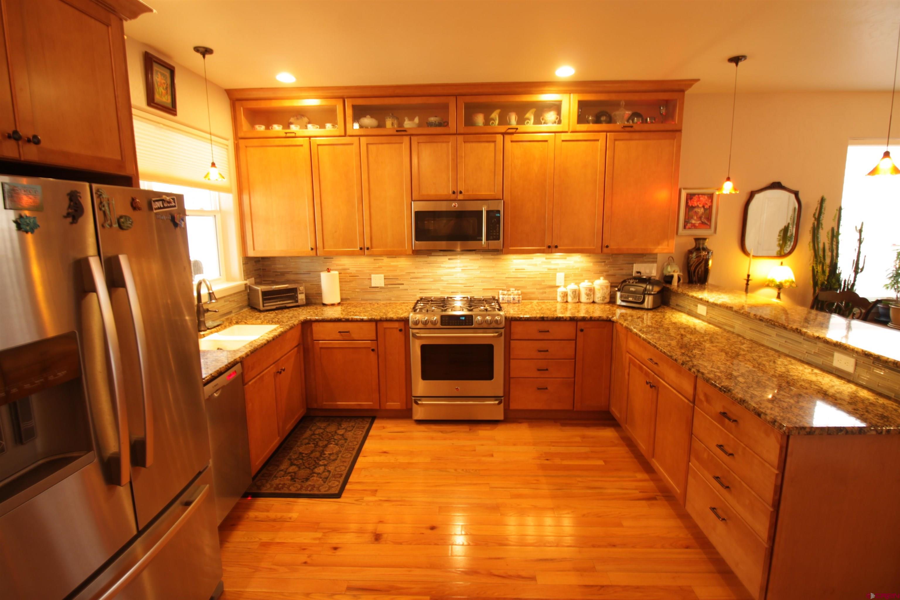 480 Oxbow Circle Durango, CO 81301 - Photo 4 of 16 a kitchen with stainless steel appliances granite countertop a stove a sink and a refrigerator
